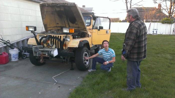 le changing the jeep's tire.jpg