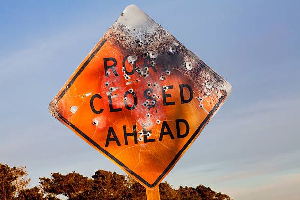 road-closed-ahead-sign-full-of-bullet-holes.jpg