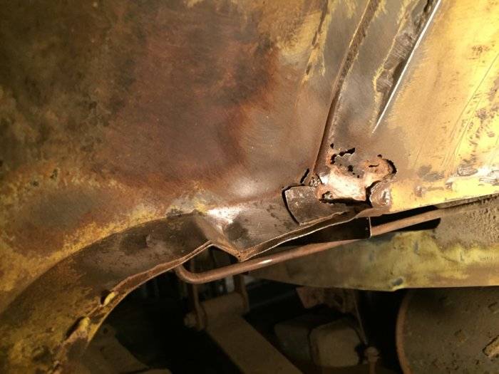 wheel well rt side showing trunk damage.jpg